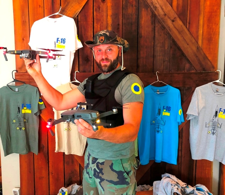 A supporter holding a drone and a Ukraine solidarity shirt