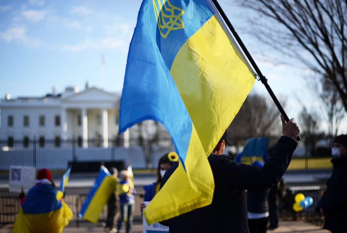 People raising Ukrainian flags in a show of solidarity outside the White House